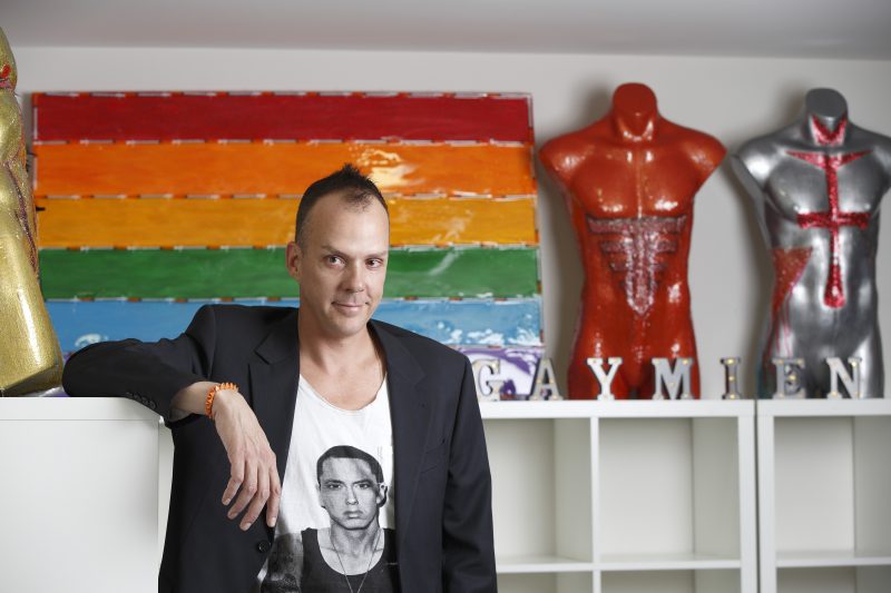 Damien Chandler pictured in front of his artwork